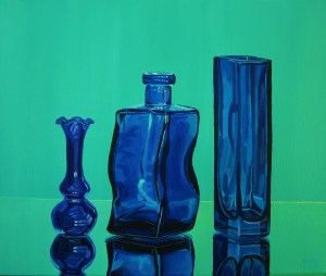 Three Blue Glass Containers on a Mirror